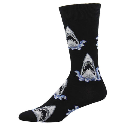 A black crew sock with a pattern of shark jaws in white and grey colors.