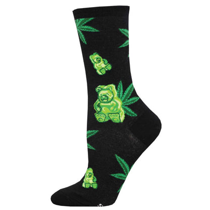 A pair of black novelty socks with a pattern of green gummy bear candies and marijuana leaves.