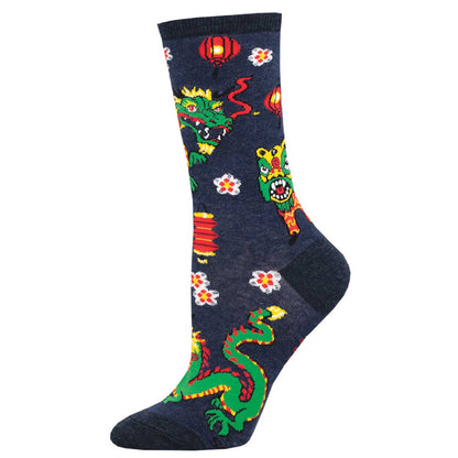 A pair of colorful crew socks with a dragon pattern and floral accents on a blue background.