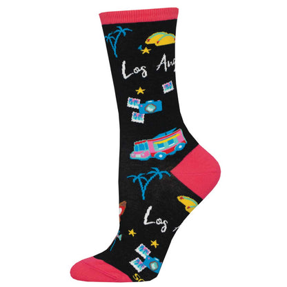 A pair of black cotton crew socks with Los Angeles text and various city-related illustrations such as a hot dog, palm trees, and a school bus.