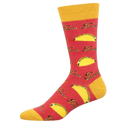 A pair of red crew socks with a pattern that includes the phrase 'Taco Tuesday' and illustrations of tacos.