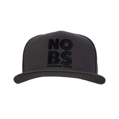 A dark grey flat bill hat with 'NO BS' #NoBoringSocks printed prominently in the center.