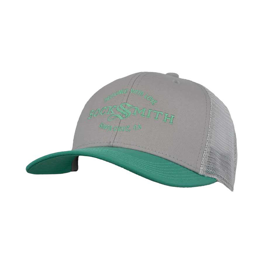 A light gray and teal trucker hat with 'SOCKSMITH' branding and the text 'DESIGNED WITH LOVE Santa Cruz, CA' on the front.